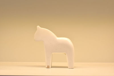 Close-up of white animal representation on table
