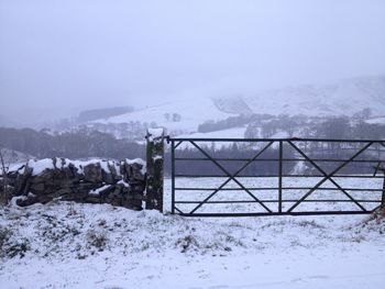 Snow covered field against sky