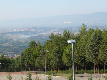 High angle view of street by trees against sky