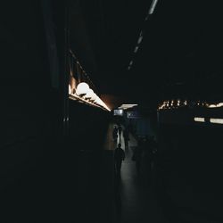People walking on footpath at night