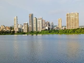 River by buildings against sky in city