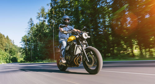 Man riding motorcycle on road