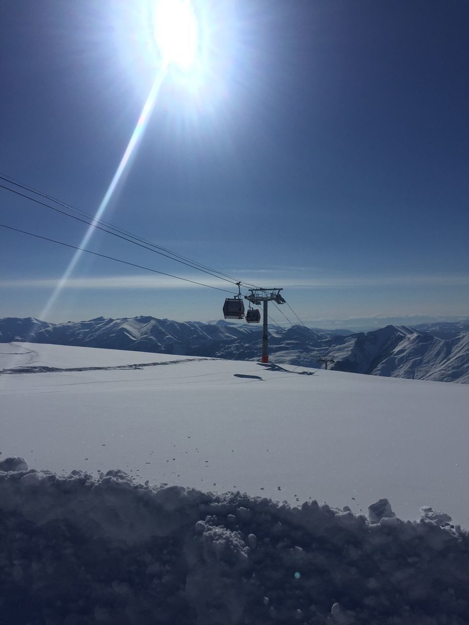 sun, snow, sunbeam, lens flare, sunlight, tranquility, landscape, tranquil scene, scenics, nature, mountain, bright, beauty in nature, weather, season, sky, sunny, blue, non-urban scene, covering, outdoors, mountain range, snowcapped mountain, day, no people, idyllic, remote