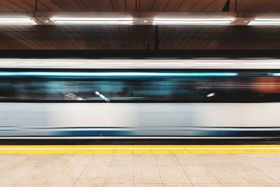 Blurred motion of train at railroad station