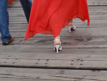 Walking in high heels looks easy when a swirling red helps propel every step. 