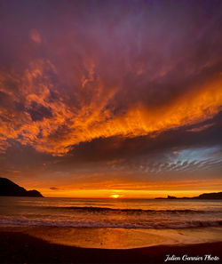 Scenic view of sea against orange sky