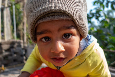 Portrait of cute boy wearing knit hat outdoors