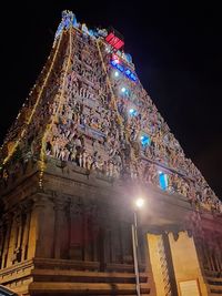 Low angle view of illuminated building against sky at night