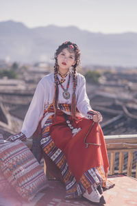 Portrait of young woman sitting on beach