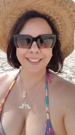 Sensuous woman wearing hat at beach