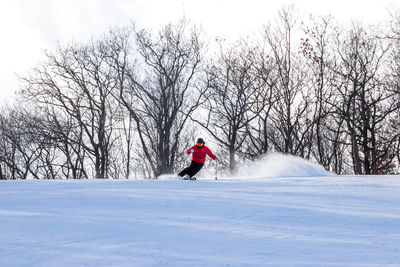 Full length of person skiing on snow against sky