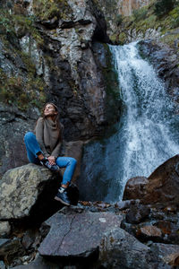 Nice girl traveler at the mistyc waterfall