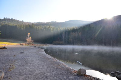 Scenic view of lake against clear sky during winter