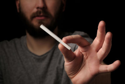 Hands bearded man with cigarette, close up. give up smoking cigarettes. 