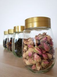 Close-up of pink flowers in jar on table