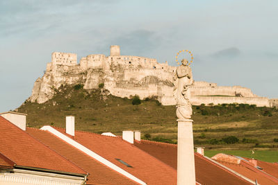 Castle spišský hrad with statue in front
