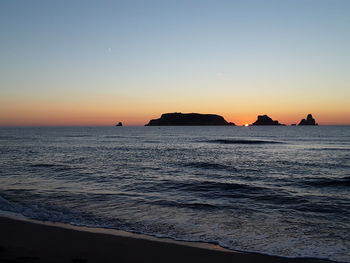 Scenic view of sea against clear sky during sunset