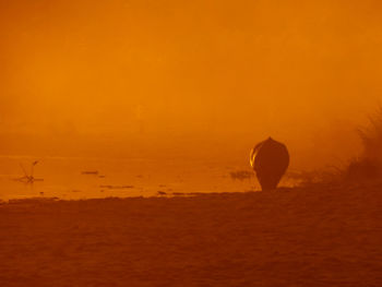 Scenic view of land against sky during sunset