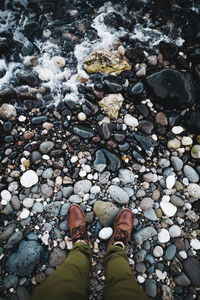Low section of person standing on rock