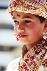 Close-up of boy in costume looking away while standing indoors