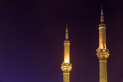 Communications tower against sky at night