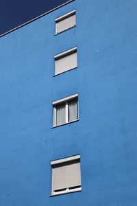 Low angle view of building against blue sky