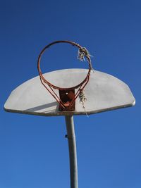 Low angle view of basketball hoop against blue sky