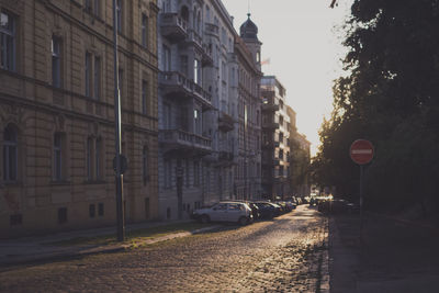 Street by buildings during sunny day