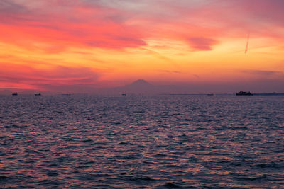 Scenic view of sea against romantic sky at sunset