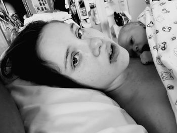 Close-up portrait of mother sleeping with newborn at hospital