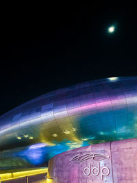 Low angle view of illuminated lights against clear sky at night