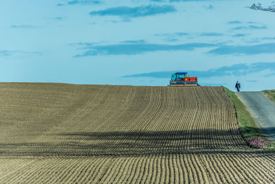 Farmer sowing with tractor