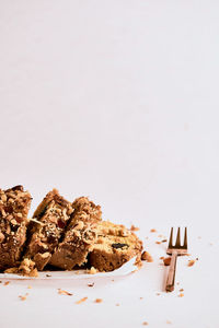 Close-up of chocolate cake on table against white background