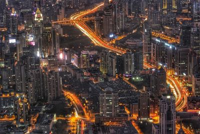 High angle view of city lit up at night