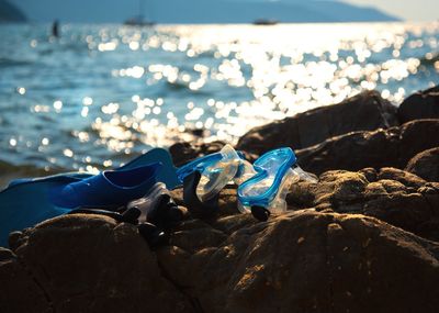 Rocks on beach against blue sky