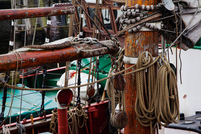 Rope hanging on boat moored at harbor