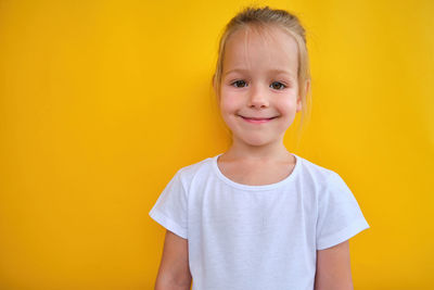 Portrait of boy against yellow background