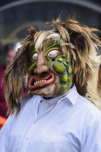 Woman wearing spooky mask during carnival