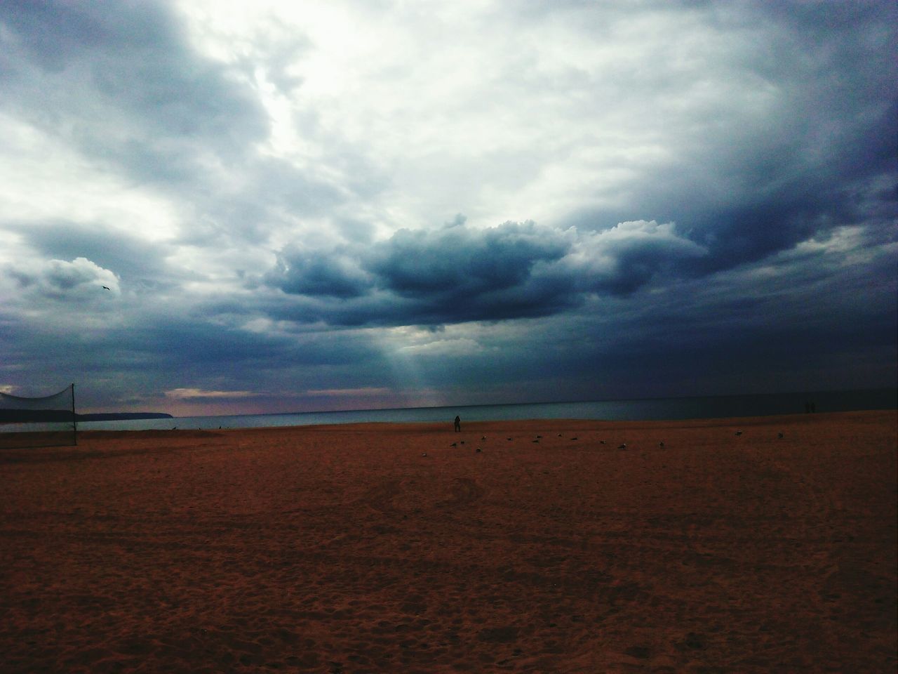 sky, sea, beach, cloud - sky, tranquil scene, tranquility, cloudy, scenics, horizon over water, water, sand, beauty in nature, shore, cloud, nature, overcast, weather, idyllic, remote, non-urban scene