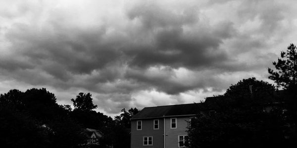 Low angle view of building against cloudy sky