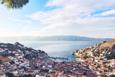 High angle view of townscape by sea against sky