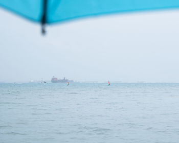 Sailboat sailing in sea against sky