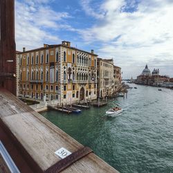 View of buildings in venezia town against cloudy sky