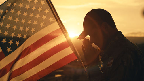 Low angle view of silhouette of man against sky during sunset