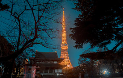 Low angle view of illuminated building against sky at night