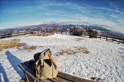 Snow covered field against sky