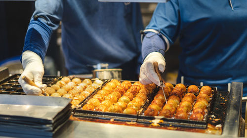 Midsection of man preparing food