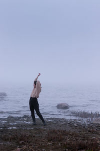Young woman in the fog on the background of the bay