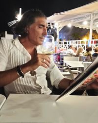 Women drinking glass on table at restaurant