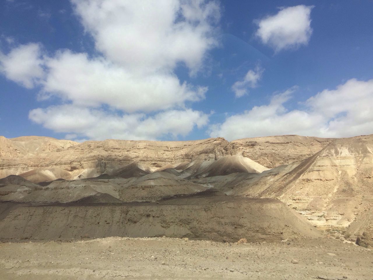 sky, cloud - sky, cloud, tranquility, landscape, day, built structure, arid climate, low angle view, desert, nature, blue, tranquil scene, outdoors, rock - object, architecture, sunlight, no people, cloudy, textured